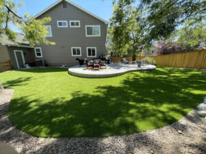 artificial turf surrounding a backyard patio